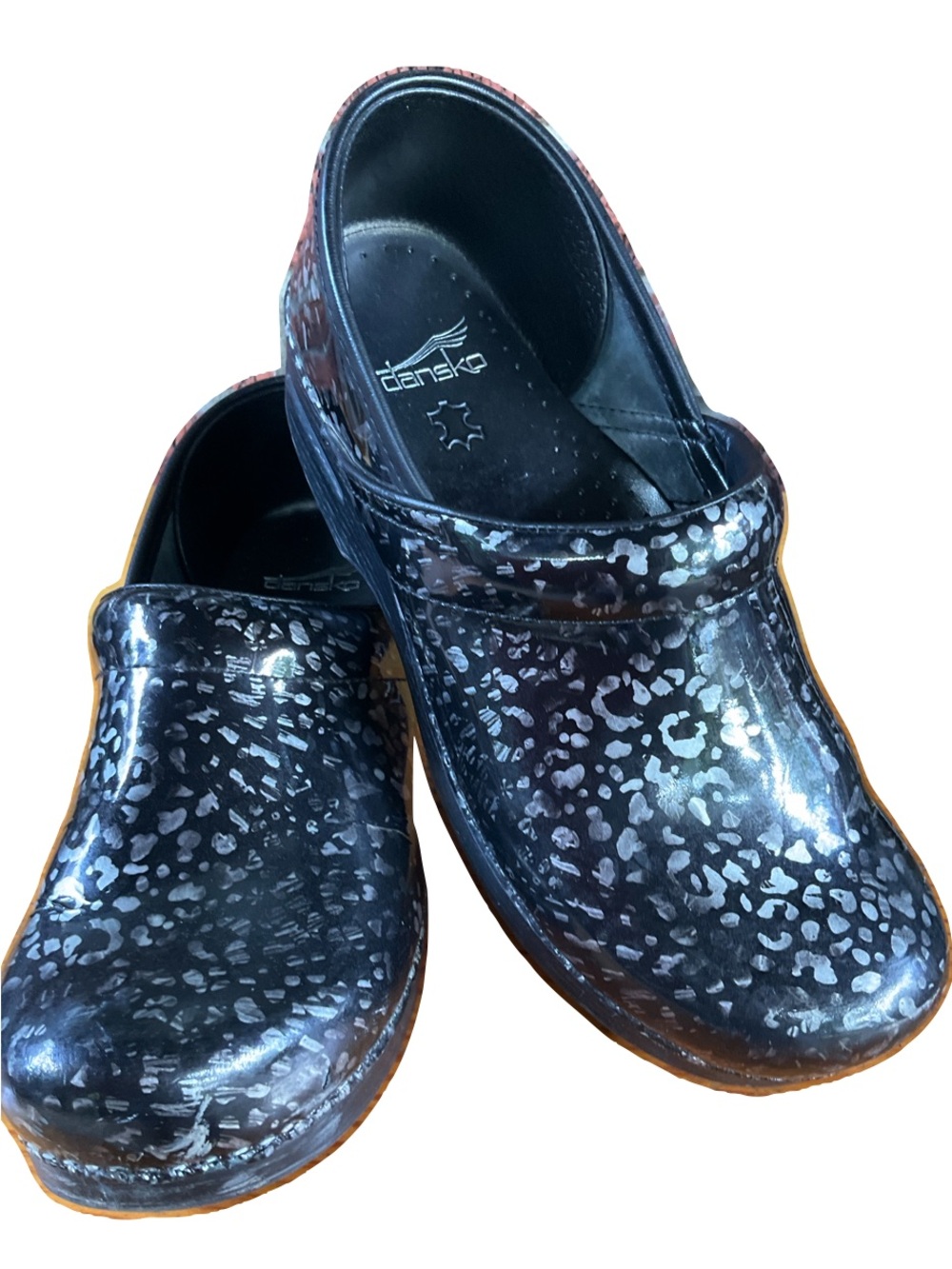 Dansko black clogs with pewter leopard print